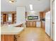 Bright eat-in kitchen featuring an island counter with seating, built-in shelving, and white appliances at 35935 Tanda Cir, Zephyrhills, FL 33541