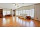 Bright living room with wood flooring, large windows, and ample natural light at 35935 Tanda Cir, Zephyrhills, FL 33541