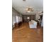 Spacious living room featuring hardwood floors, built-in shelving, and natural light from large windows at 35935 Tanda Cir, Zephyrhills, FL 33541