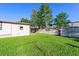 Grass backyard with clothesline and partial home view at 35935 Tanda Cir, Zephyrhills, FL 33541