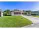 Single-wide manufactured home with carport and spacious lawn at 35935 Tanda Cir, Zephyrhills, FL 33541