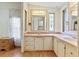Double sink bathroom with a large mirror and window at 35935 Tanda Cir, Zephyrhills, FL 33541