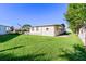 Home's backyard showcasing a grassy lawn at 35935 Tanda Cir, Zephyrhills, FL 33541