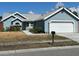 One-story house with a gray exterior, white garage door and walkway at 3529 65Th Avenue E Cir, Sarasota, FL 34243