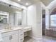 Elegant bathroom featuring a large vanity, soaking tub, and walk-in shower at 18065 Wing Ave, Port Charlotte, FL 33948