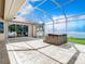 Covered patio with hot tub and view of yard at 18065 Wing Ave, Port Charlotte, FL 33948