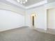 Primary bedroom with carpet floors and access to the ensuite bathroom at 18065 Wing Ave, Port Charlotte, FL 33948