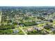 Aerial view of a residential neighborhood showcasing a variety of homes and lush landscaping at 18065 Wing Ave, Port Charlotte, FL 33948