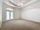Spacious Primary bedroom with carpet floors and double doors to the patio at 18065 Wing Ave, Port Charlotte, FL 33948