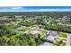 Aerial view of a home in a quiet, residential neighborhood with mature trees at 18065 Wing Ave, Port Charlotte, FL 33948