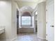 Bathroom with a garden tub, a separate shower, and a large window at 18065 Wing Ave, Port Charlotte, FL 33948