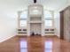 Living room with hardwood floors, built-in shelving, and fireplace at 18065 Wing Ave, Port Charlotte, FL 33948