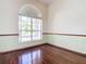 Bright bedroom with hardwood floors and a large arched window at 18065 Wing Ave, Port Charlotte, FL 33948