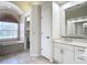 Bathroom with double sinks, a large mirror, and a separate toilet area at 18065 Wing Ave, Port Charlotte, FL 33948