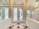 Elegant entryway with double doors and stained glass, featuring a tiled floor at 18065 Wing Ave, Port Charlotte, FL 33948