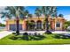 Beautiful two-story home with palm trees and a large driveway at 18065 Wing Ave, Port Charlotte, FL 33948