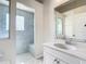 Bathroom with vanity, shower, and large mirror at 18065 Wing Ave, Port Charlotte, FL 33948