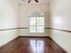 Bright bedroom with hardwood floors and a large arched window at 18065 Wing Ave, Port Charlotte, FL 33948