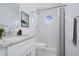 Clean bathroom with white subway tile, granite countertop, and octagon window at 3540 65Th Avenue E Cir, Sarasota, FL 34243