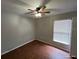 Bedroom with wood-look flooring and a window with blinds at 6115 Sand Key Ln, Wesley Chapel, FL 33545