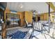 Comfortable patio furniture and a view into the home's interior at 12377 Fillmore St, Spring Hill, FL 34609