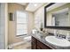 Powder room with granite countertop, large mirror, and window at 12377 Fillmore St, Spring Hill, FL 34609