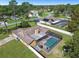 Aerial view showcasing a single-Gathering home with a screened pool and spacious backyard in a residential area at 12377 Fillmore St, Spring Hill, FL 34609