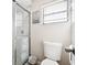 Clean bathroom with shower, toilet, and a window for natural light at 12377 Fillmore St, Spring Hill, FL 34609