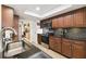 Modern kitchen with granite countertops, stainless steel appliances, and dark wood cabinets at 12377 Fillmore St, Spring Hill, FL 34609