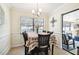 Bright dining room with table for four, view into Gathering room and pool at 12377 Fillmore St, Spring Hill, FL 34609