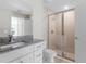 Bathroom with granite countertop, shower, and white vanity at 3841 San Pedro Ave, North Port, FL 34288