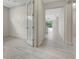 Bright hallway with tile flooring, leading to other rooms at 7615 Campus Cv, Sarasota, FL 34243