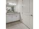 Modern bathroom with white vanity and granite top at 7615 Campus Cv, Sarasota, FL 34243