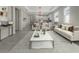 Bright living room features an open floor plan, connecting to the kitchen and dining area at 7615 Campus Cv, Sarasota, FL 34243