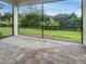 Spacious screened patio with paver tile floor and lush backyard view at 7615 Campus Cv, Sarasota, FL 34243