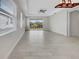 Spacious living area with tile floors and sliding doors at 7615 Campus Cv, Sarasota, FL 34243