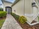 Well-maintained exterior with a paved walkway and landscaping at 7615 Campus Cv, Sarasota, FL 34243