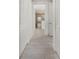 Bright hallway with white doors and tile floors at 7615 Campus Cv, Sarasota, FL 34243