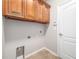 Laundry room with wood cabinets and tile flooring at 11354 78Th E St, Parrish, FL 34219