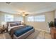 Comfortable bedroom with a large bed, ceiling fan, and natural light from two windows at 10226 Willow Dr, Port Richey, FL 34668