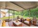 Inviting screened porch with stylish outdoor seating and a view of the lush backyard at 10226 Willow Dr, Port Richey, FL 34668