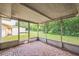 View of the screened porch with access to the backyard, providing an outdoor living space at 10226 Willow Dr, Port Richey, FL 34668