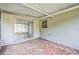 Screened porch featuring tile flooring and access to the home's interior at 10226 Willow Dr, Port Richey, FL 34668