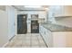 Updated kitchen featuring white cabinets, granite countertops, and black appliances at 10226 Willow Dr, Port Richey, FL 34668