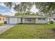 Ranch-style home with a white garage door at 10226 Willow Dr, Port Richey, FL 34668