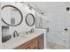 Modern bathroom with double vanity, frameless shower, and marble tile at 265 Belvedere Ct, Punta Gorda, FL 33950