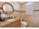 Updated bathroom features a granite vanity, tiled floors, and a large vanity mirror at 265 Belvedere Ct, Punta Gorda, FL 33950