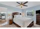 Bedroom with a queen-size bed, TV, and a view of the dining area at 265 Belvedere Ct, Punta Gorda, FL 33950