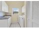 Bright laundry room with washer, dryer, cabinets, and a utility sink at 265 Belvedere Ct, Punta Gorda, FL 33950