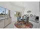Bright dining room with a glass table and four chairs, a lovely rug, and large windows at 265 Belvedere Ct, Punta Gorda, FL 33950
